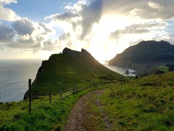 Scenic view of sea and mountains against sky