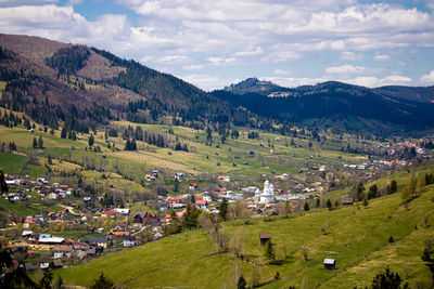 High angle view of townscape and mountains against sky