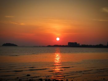 Scenic view of sea against romantic sky at sunset