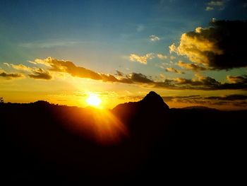 Scenic view of silhouette mountains against sky during sunset