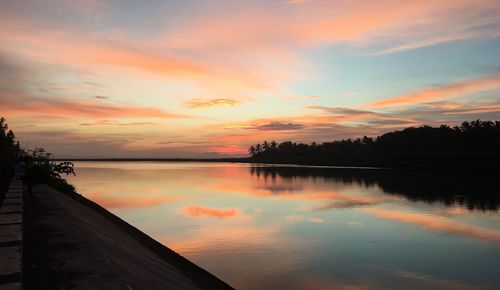 Scenic view of lake against romantic sky at sunset