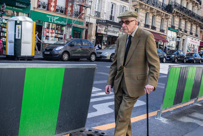 Full length of a man walking on street in city