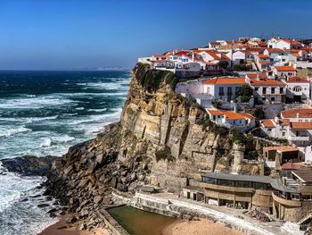 Panoramic view of sea and buildings against sky