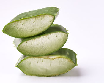 Close-up of aloe vera slices against white background