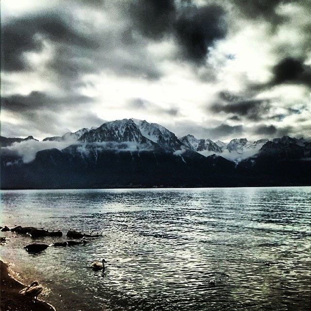 mountain, mountain range, water, tranquil scene, scenics, lake, sky, tranquility, beauty in nature, waterfront, cloud - sky, winter, cold temperature, snow, nature, snowcapped mountain, cloudy, weather, cloud, idyllic