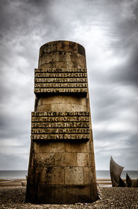 Low angle view of historical building against cloudy sky