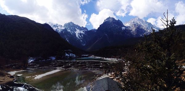 Scenic view of mountains against cloudy sky