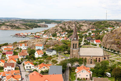 High angle view of townscape by sea against sky