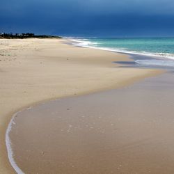 Scenic view of sea against cloudy sky