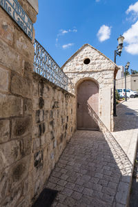 Corridor of historic building against sky