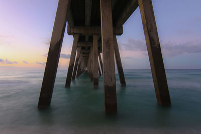 Low angle view of pier at sunset