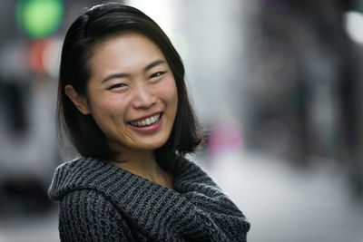 Close-up portrait of happy young woman outdoors