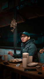 Young man drinking coffee at table