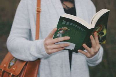 Close-up of hand holding book