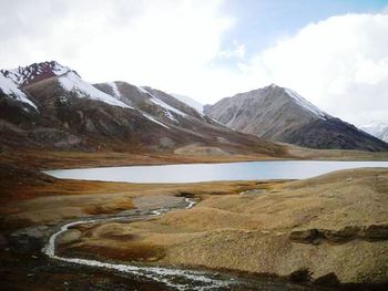 Scenic view of landscape against cloudy sky