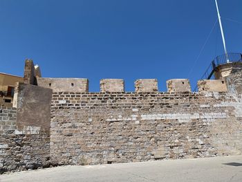 Low angle view of historical building against blue sky