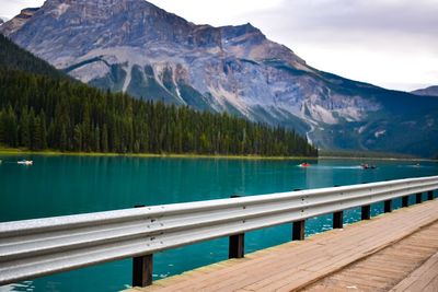 Scenic view of lake by mountains against sky