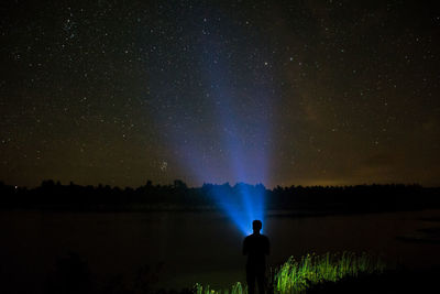 Person holding light at night