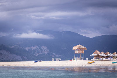 Scenic view of sea and mountains against sky