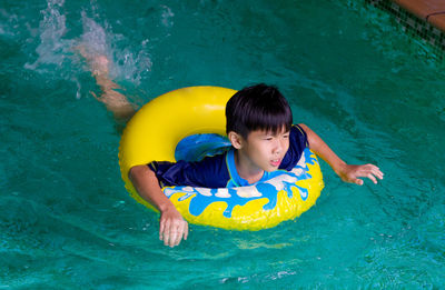 Happy boy swimming in pool