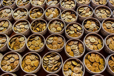 Full frame shot of coins in containers