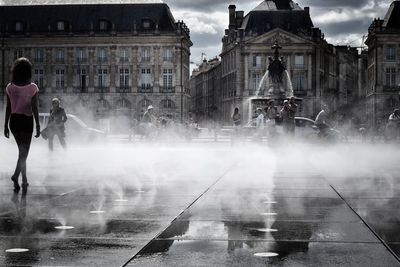 People on water in city