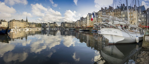 Panoramic view of canal and buildings against sky