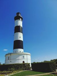 Low angle view of lighthouse against blue sky