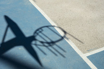 Shadow of basketball hoop on court