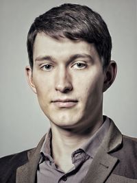 Portrait of young man against gray background