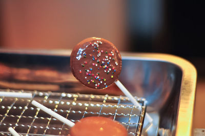 Close-up of chocolate candies on cooling rack