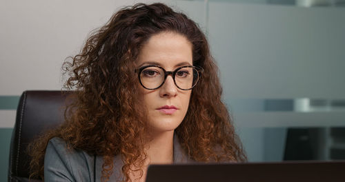 Concentrated businesswoman working online on computer. 