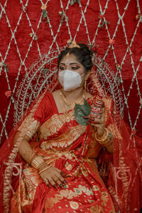 Portrait of woman with red umbrella