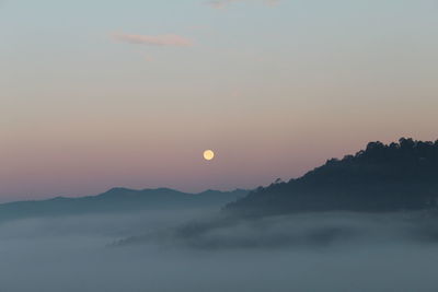 Scenic view of silhouette mountains against sky during sunset