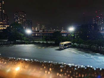 Illuminated city street and buildings at night