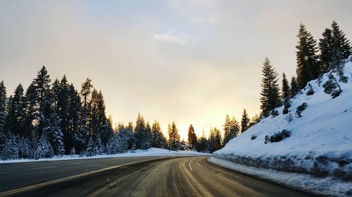 Road passing through snow covered landscape