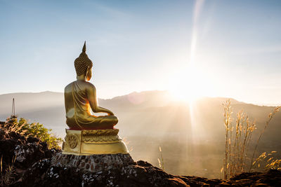 Statue of buddha against sky