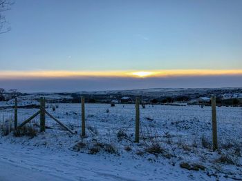 Scenic view of frozen sea against sky during winter