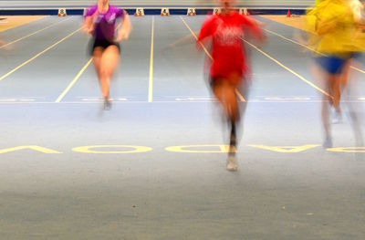 Blurred motion of people running on road