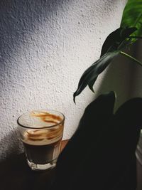 Close-up of coffee on table against wall