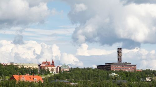 Panoramic view of buildings in town against sky