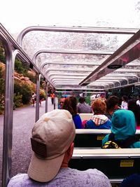 Rear view of people sitting in train