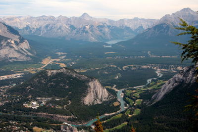 High angle view of valley and mountains against sky