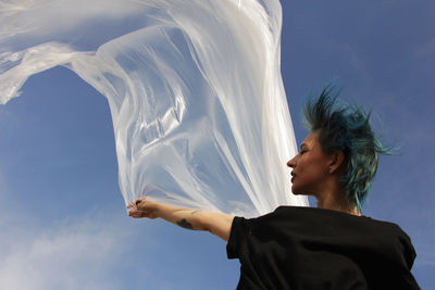 Low angle view of woman against sky