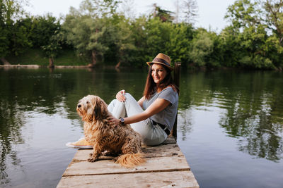 Young woman with dog in lake