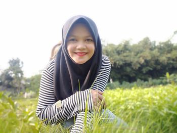 Portrait of smiling girl on field