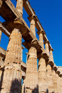 Low angle view of historical building against blue sky