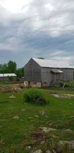 Abandoned building on field against sky