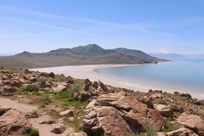 Scenic view of sea and mountains against sky