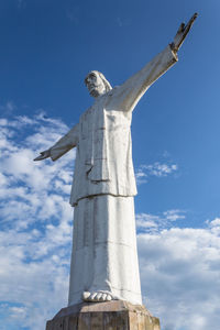 Low angle view of cross against blue sky